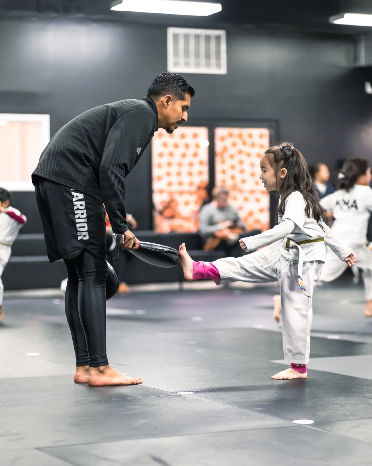 A Warrior student receiving a new belt at a promotion